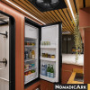 Réfrigérateur 90l noir Nomadic Ark ouvert et rempli dans un fourgon aménagé