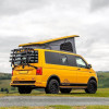 Volkswagen California gris, toit relevable ouvert, fenêtre coulissante avant droite, vue 3/4 avant